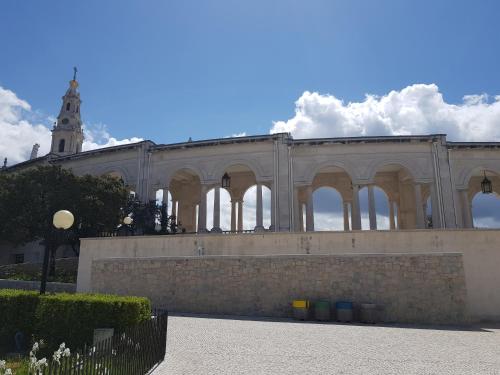 a large building with a clock tower in the background at Casa dos Tios in Fátima