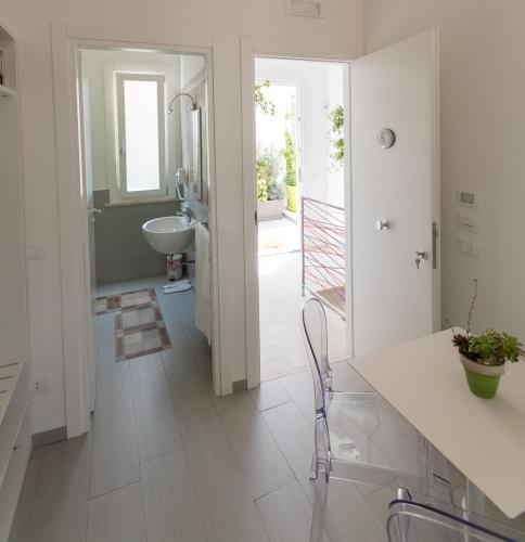 a white bathroom with a sink and a toilet at B&B MARSALA in Marsala