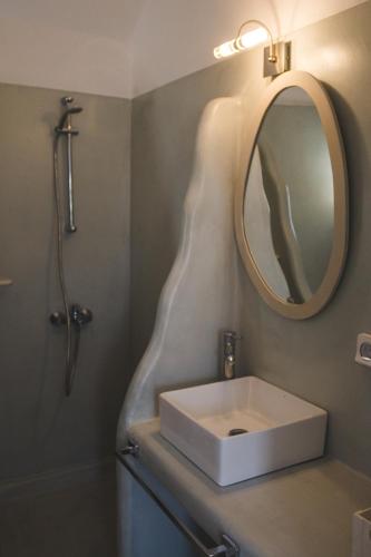 a bathroom with a sink and a mirror at Cultural House in Pirgos