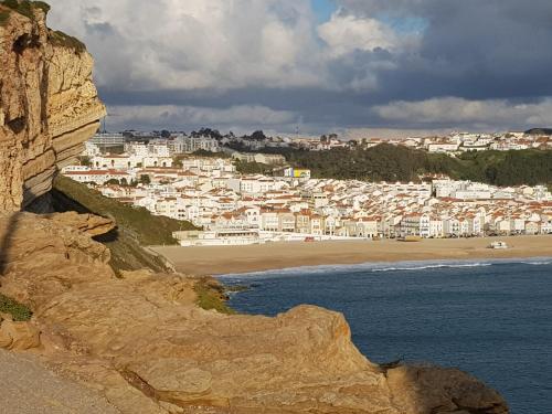 a view of a beach with a town in the background at Casa dos Tios in Fátima