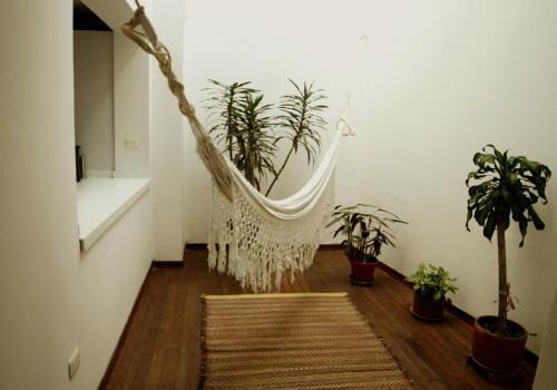 a hammock in a room with potted plants at Magdalena Guest House in Bogotá