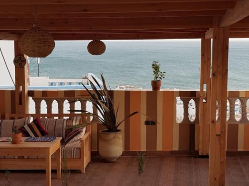 a living room with a view of the ocean at Dar Surf in Taghazout
