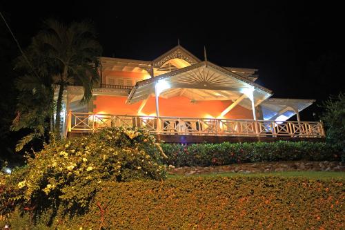 a house with lights on the front of it at night at Plantation Beach Villas in Black Rock