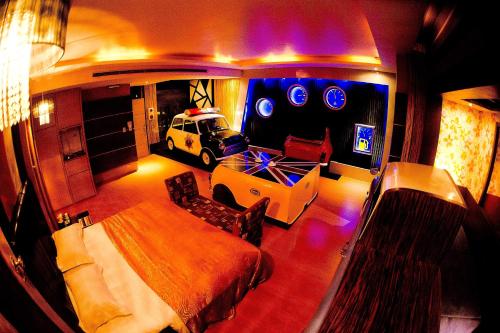 a room with a bed and a car in it at Water City Motel in Daya