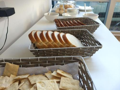 twee manden brood en kaas op een tafel bij Ciudad Prado Hotel in Cordoba