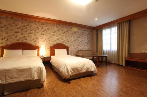 a hotel room with two beds and a window at Karak Tourist Hotel in Seoul