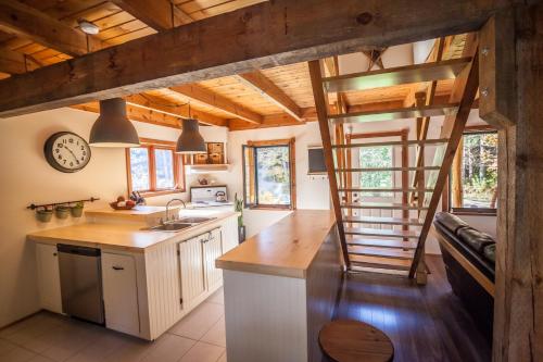 una cocina con una escalera de caracol en una casa en Waterfall Cottage, en Sainte-Melanie