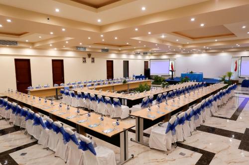 a row of tables and chairs in a banquet hall at Vila Ombak in Gili Trawangan