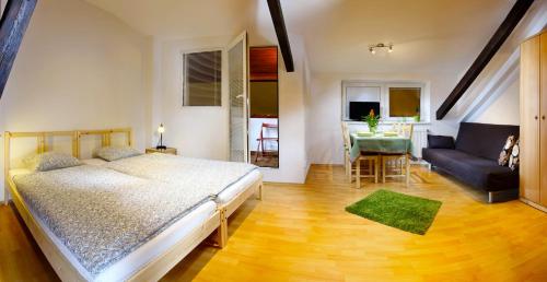 a bedroom with a bed and a couch and a table at Panorama in Brno