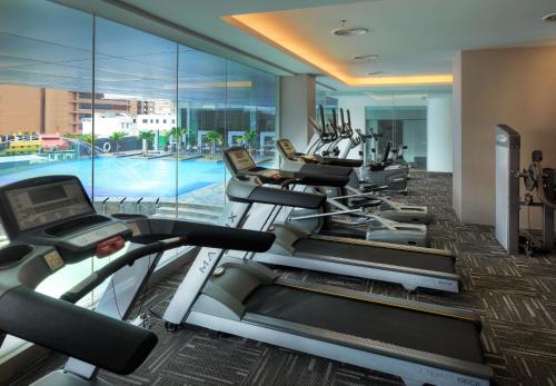 a gym with several treadmills and a pool at Furama Bukit Bintang, Kuala Lumpur in Kuala Lumpur