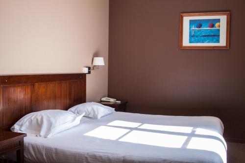 En eller flere senge i et værelse på Domaine du Pont de l'Eyre