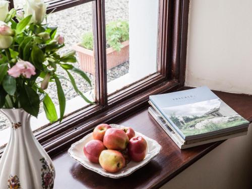 a plate of fruit on a table next to a window at Shepherds' Retreat in Greencastle