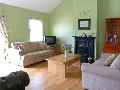 a living room with two couches and a coffee table at The Bay in Caherdaniel