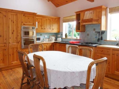 a kitchen with a table and chairs in a kitchen at The Range in Enniscorthy