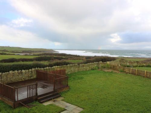 an aerial view of a yard with a stone wall and the ocean at Benbulben View in Tullaghan