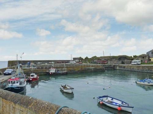 a group of boats are docked in a harbor at Seascape in Fethard on Sea