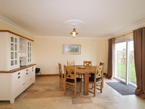 a kitchen and dining room with a table and chairs at Benbulben View in Tullaghan