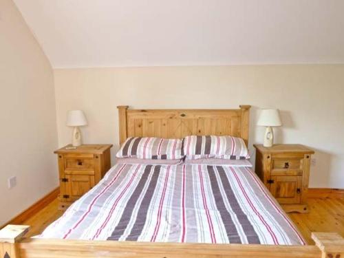 a bedroom with a large bed with two night stands at Sallywood House in Corraffrin