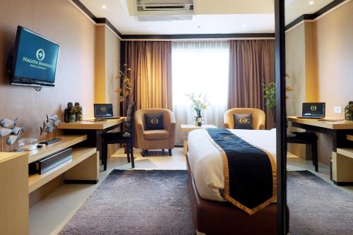 a hospital room with a bed and desks and a tv at Nagoya Mansion Hotel and Residence in Nagoya