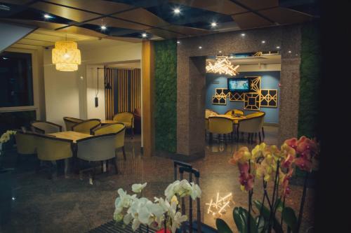 a restaurant with tables and chairs in a room at Ukraina Hotel in Cherkasy