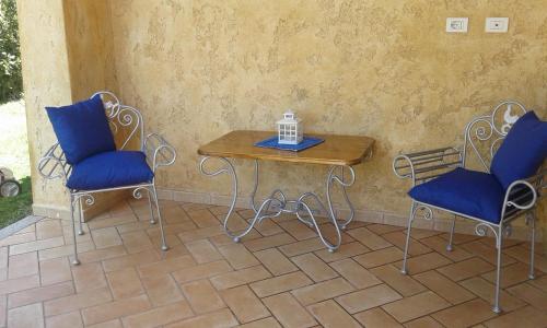 un tavolo con due sedie e un tavolo con un computer portatile di Viletta Caposchiera a Olbia