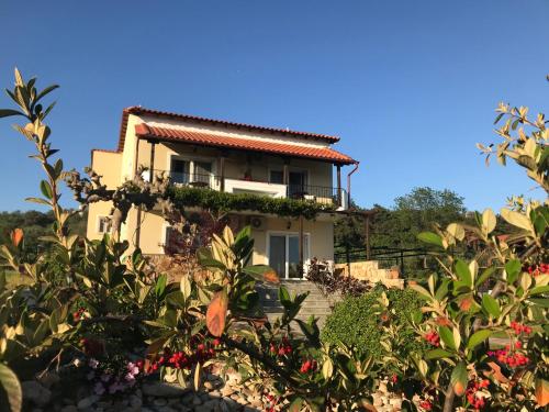 a house in the middle of a garden at Agnanti in Ávdhira