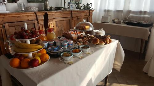a table with fruits and other food on it at Hotel Santa Marina Antica Foresteria in Santa Marina Salina