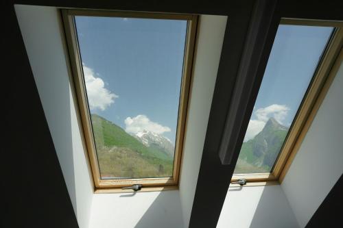 two windows in a room with a view of a mountain at Krona Apartments in Bovec