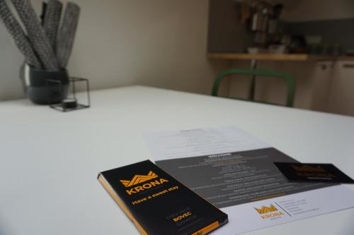 a book sitting on top of a white table at Krona Apartments in Bovec
