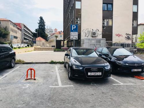 two black cars parked in a parking lot at Hotel Villa Diana in Split