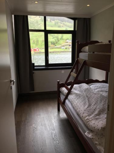 a bedroom with two bunk beds and a window at Olden apartments 1 in Olden
