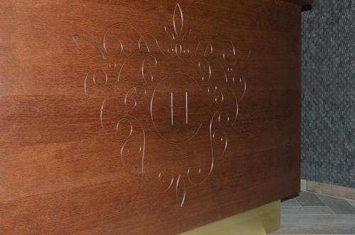 a wooden wall with a drawing on it at Central Hotel Radviliškis in Radviliškis