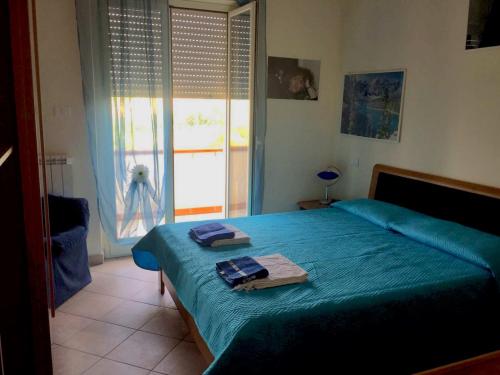 Un dormitorio con una cama azul con toallas. en VillaAnna Panoramico, en San Valentino in Abruzzo Citeriore