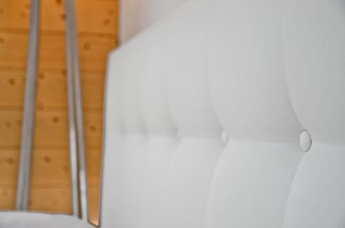 a room with white walls and a ladder at Apartment Silbersee - GRIWA RENT AG in Grindelwald