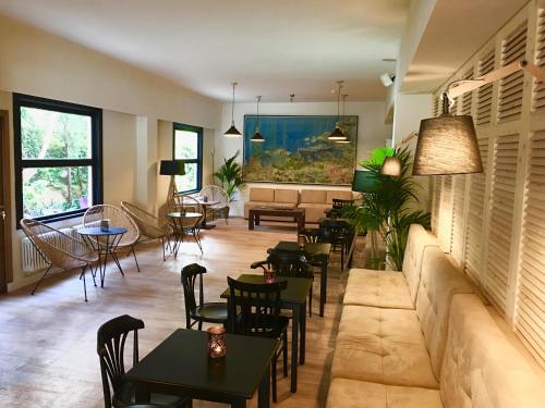 a restaurant with tables and chairs and a large painting on the wall at Hotel Miramar in Port de Soller