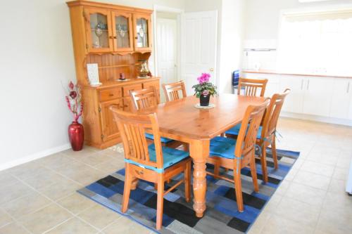 a dining room with a wooden table and chairs at Emu Lodge Country Retreat in Lal Lal