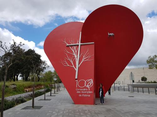 a large red heart statue with a tree on it at Casa dos Tios in Fátima