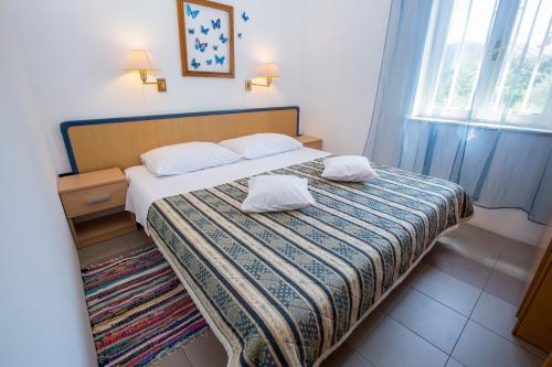 A bed or beds in a room at Apartments Goga