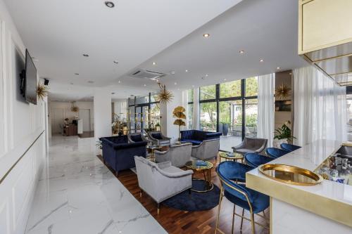 a lobby of a hotel with blue chairs and tables at Art Hotel in Split