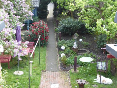 a garden with tables and chairs and flowers at Großstrasse 18 B in Leer