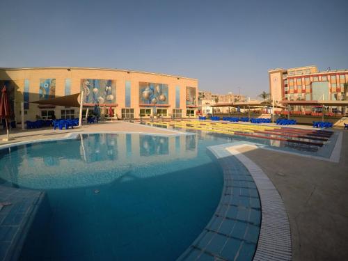 a large swimming pool in front of a building at Rehana Plaza Hotel in Cairo