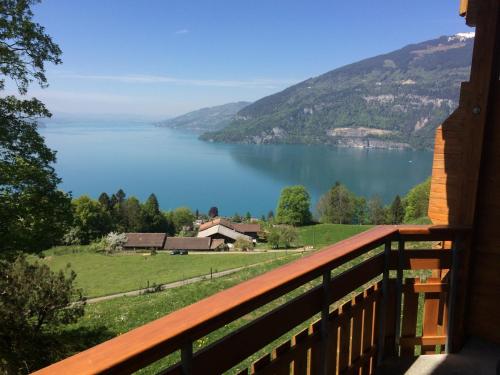 a view of a lake from a house balcony at Hotel Meielisalp in Leissigen