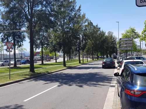 a street with cars parked on the side of the road at Next to the Airport in Moreira