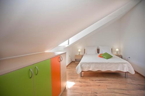 a bedroom with a bed with a colorful cabinet at Nerica Apartment in Zavalatica