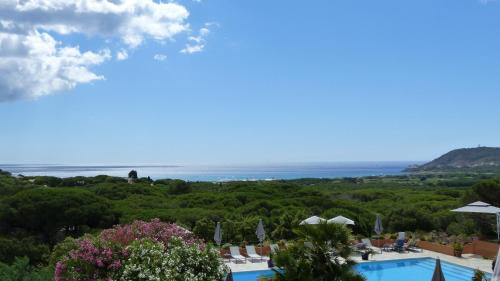 a view of the ocean from a resort with a swimming pool at Hôtel les Bouis - Vue mer in Saint-Tropez