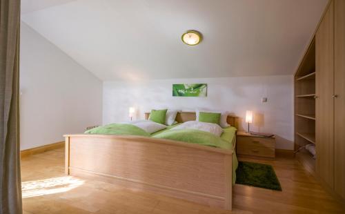 a bedroom with a wooden bed with a clock on the wall at Heidinger in Oberaudorf