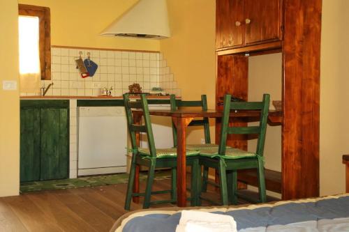 a kitchen with a table and chairs in a room at Casale Vigna Carbona in Gavorrano