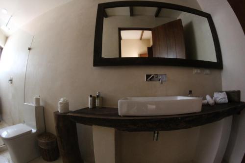 a bathroom with a sink and a mirror on the wall at Maria Del Mar Tulum - Adults Only in Tulum