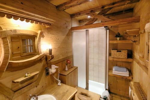 a wooden bathroom with a sink and a toilet at Seegasthof Gamsjaga in Sankt Gilgen