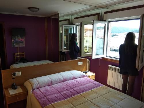 Ένα ή περισσότερα κρεβάτια σε δωμάτιο στο Hostal Residencia Bahía